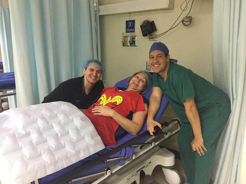 An Explant patient resting before surgery with Dr. Urzola and a nurse in Costa Rica