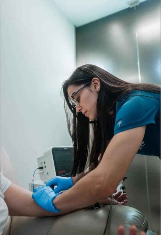 A nurse preparing an intravenous infusion at RMI Health's clinic